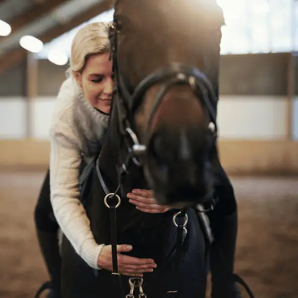 Person sitting quietly on a horse, sharing a peaceful moment of connection during the Meditative Riding Experience at LNK Performance Horses.